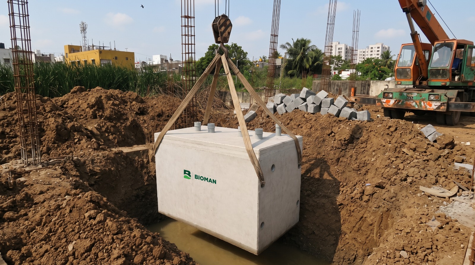 Crane lowering a green Bioman tank into position